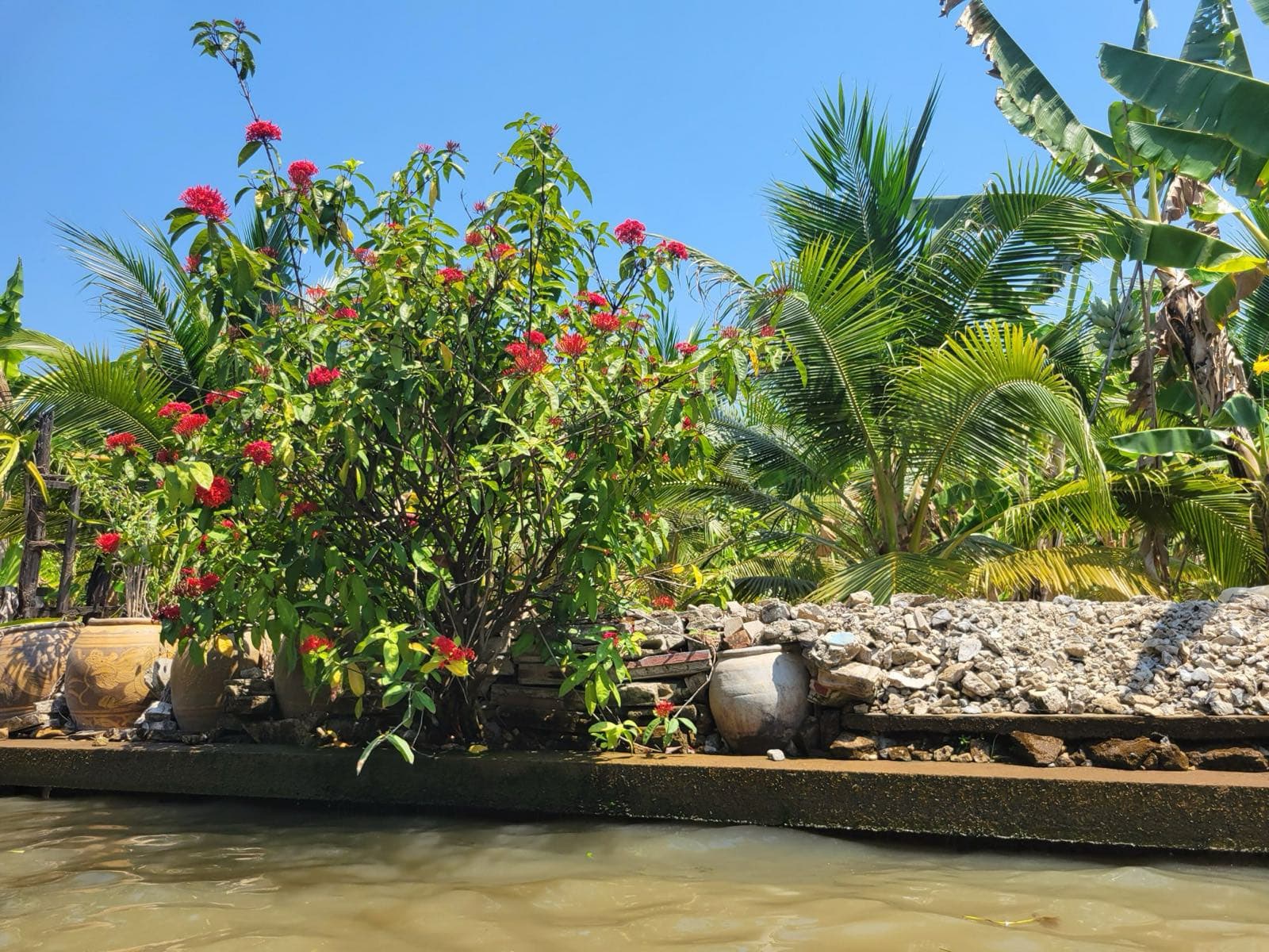 Boats along the banks of a canal at Damnoen Saduak
